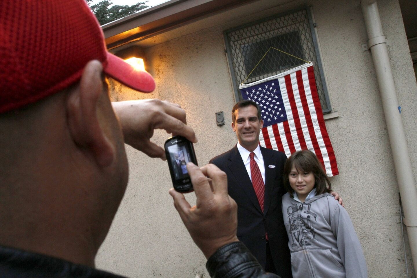 Carlos Lopez takes a photo of his 10-year-old son Kenneth with mayoral candidate Eric Garcetti at the polling station in Allesandro Elementary School in Silver Lake.