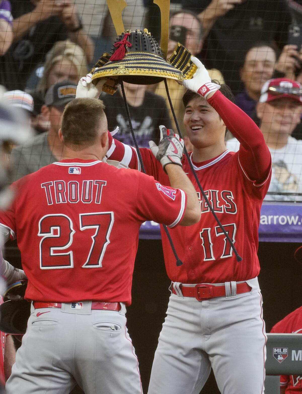 The Angels' Shohei Ohtani puts the home run hat on Mike Trout after Trout followed Ohtani's blast with his own June 23, 2023.