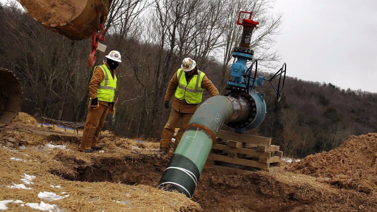 Men work on a natural gas valve at a fracking site in South Montrose, Pa. An analysis of more than 1.1 million Pennsylvania births finds that that babies born to mothers living within 1 kilometer of active “fracking” wells are 25% more likely to exhibit low birthweight.