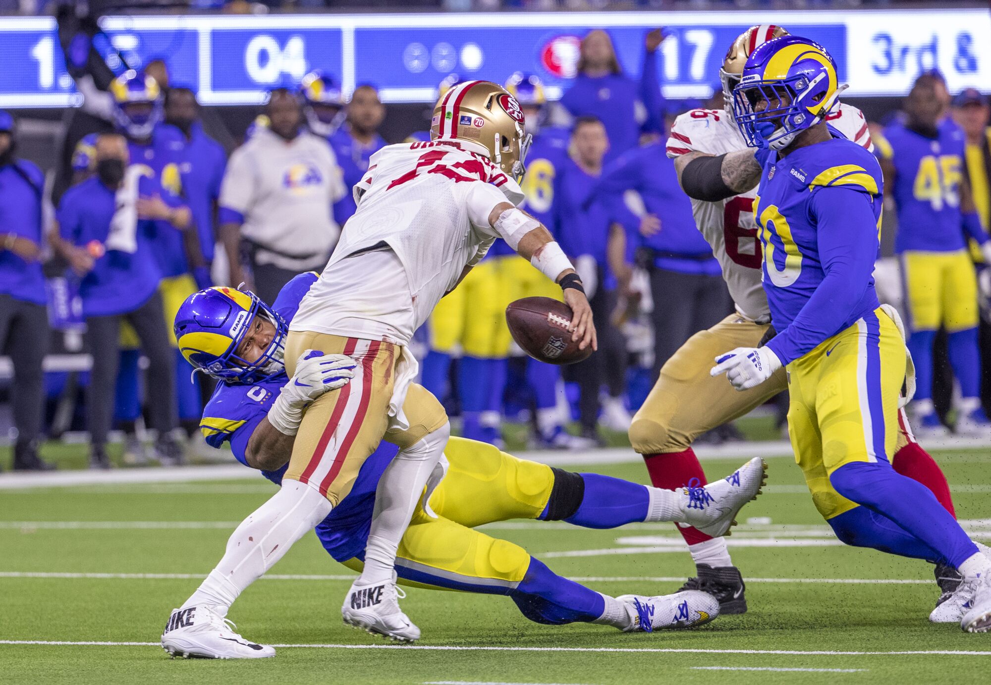Rams defensive end Aaron Donald pressures 49ers quarterback Jimmy Garoppolo late in the fourth quarter.