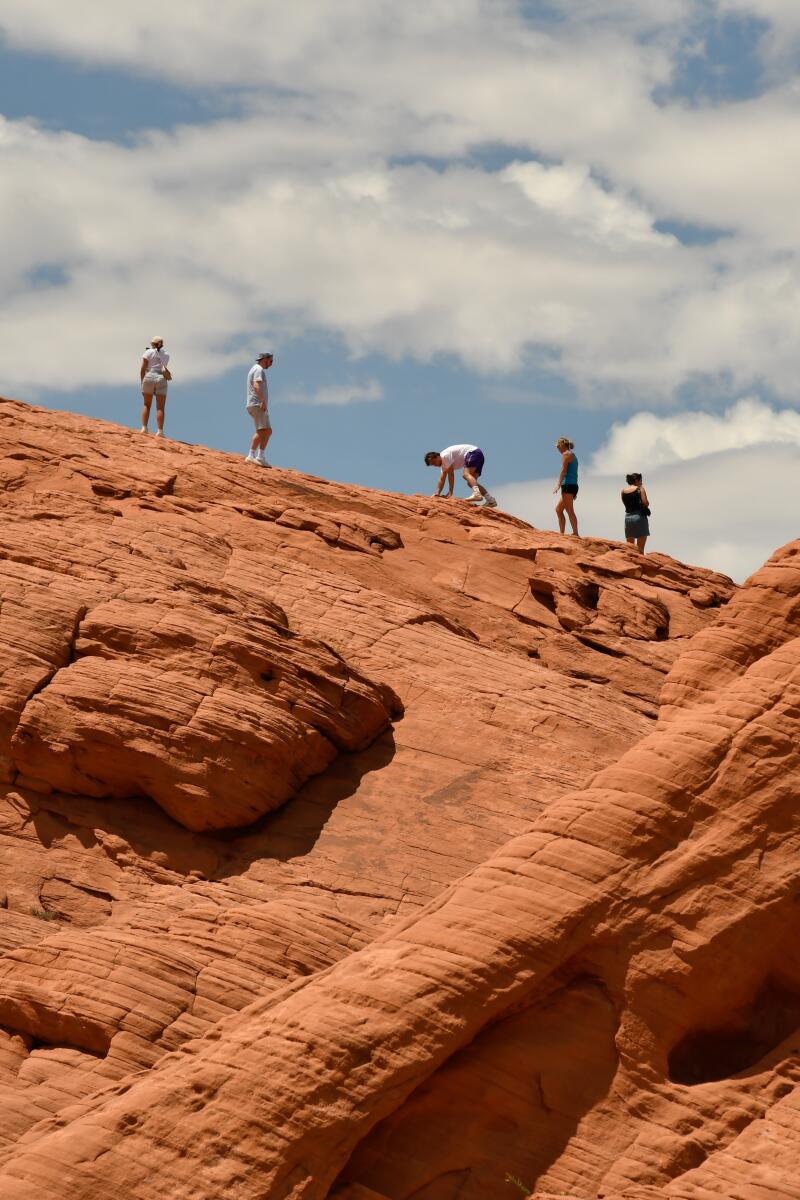 People hike on red rocks at Valley of Fire State Park 