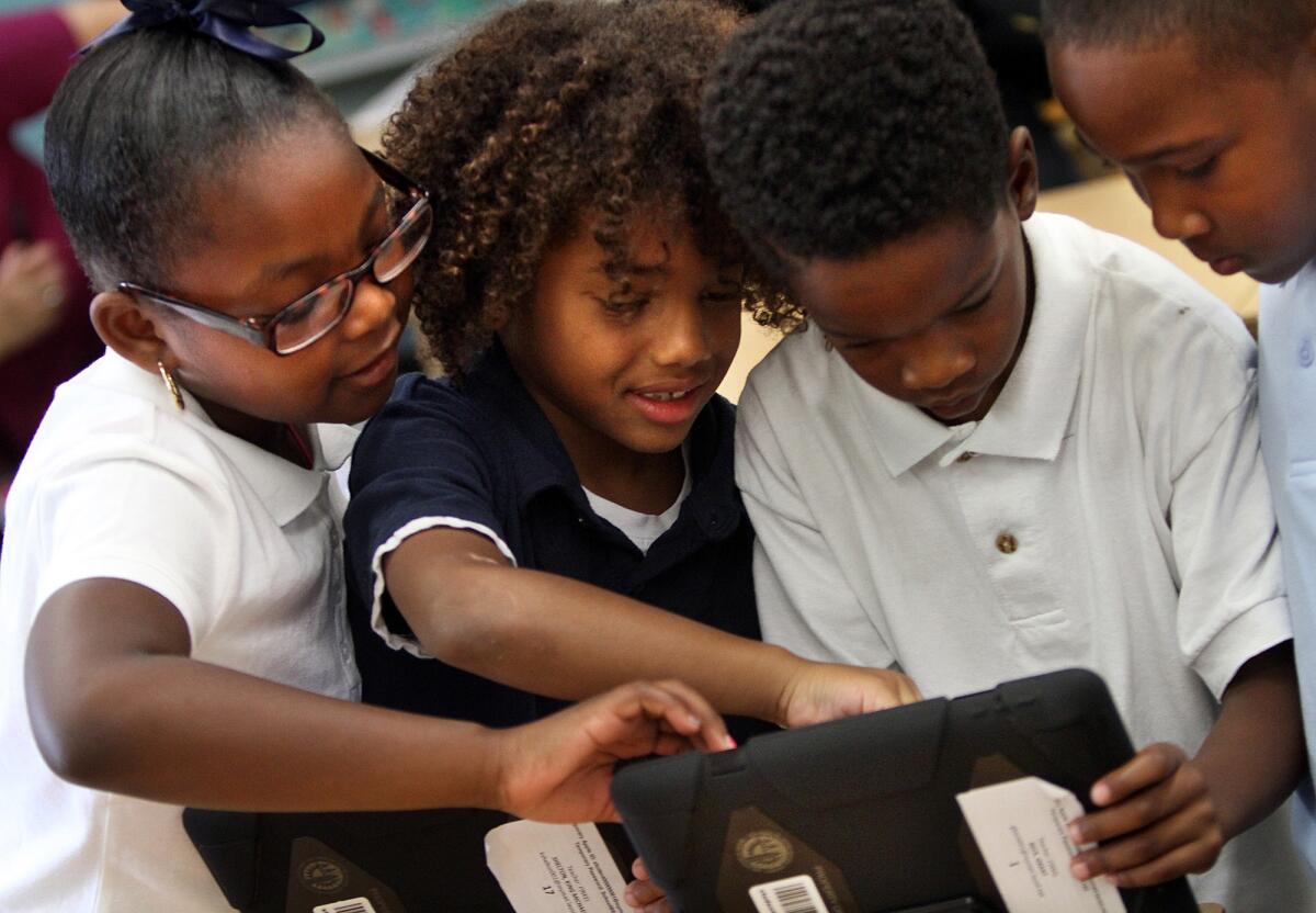 Students try out iPads provided by L.A. Unified early in the school year.