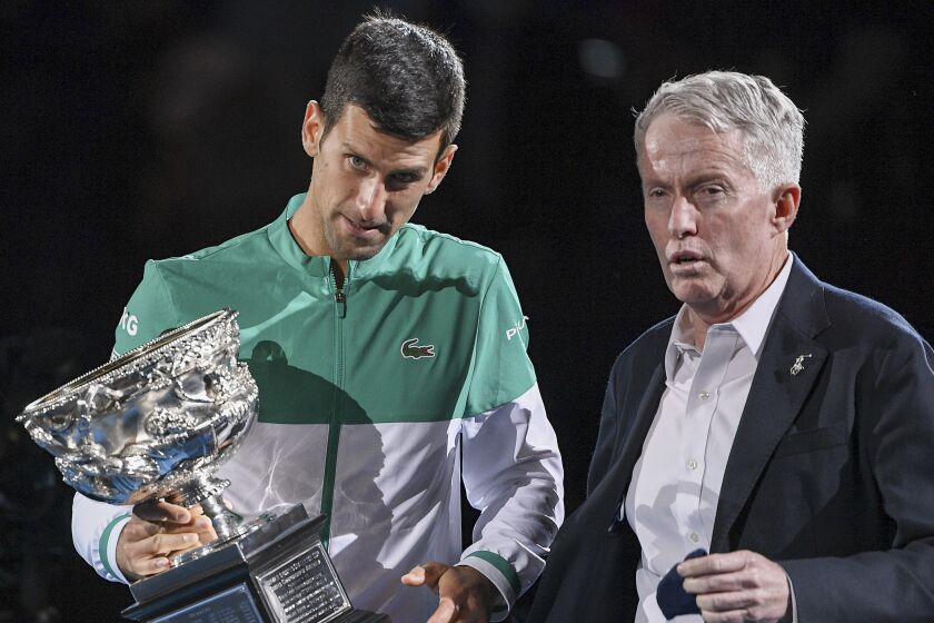 Serbia's Novak Djokovic, left, stands with Australian Open tournament director Craig Tiley.