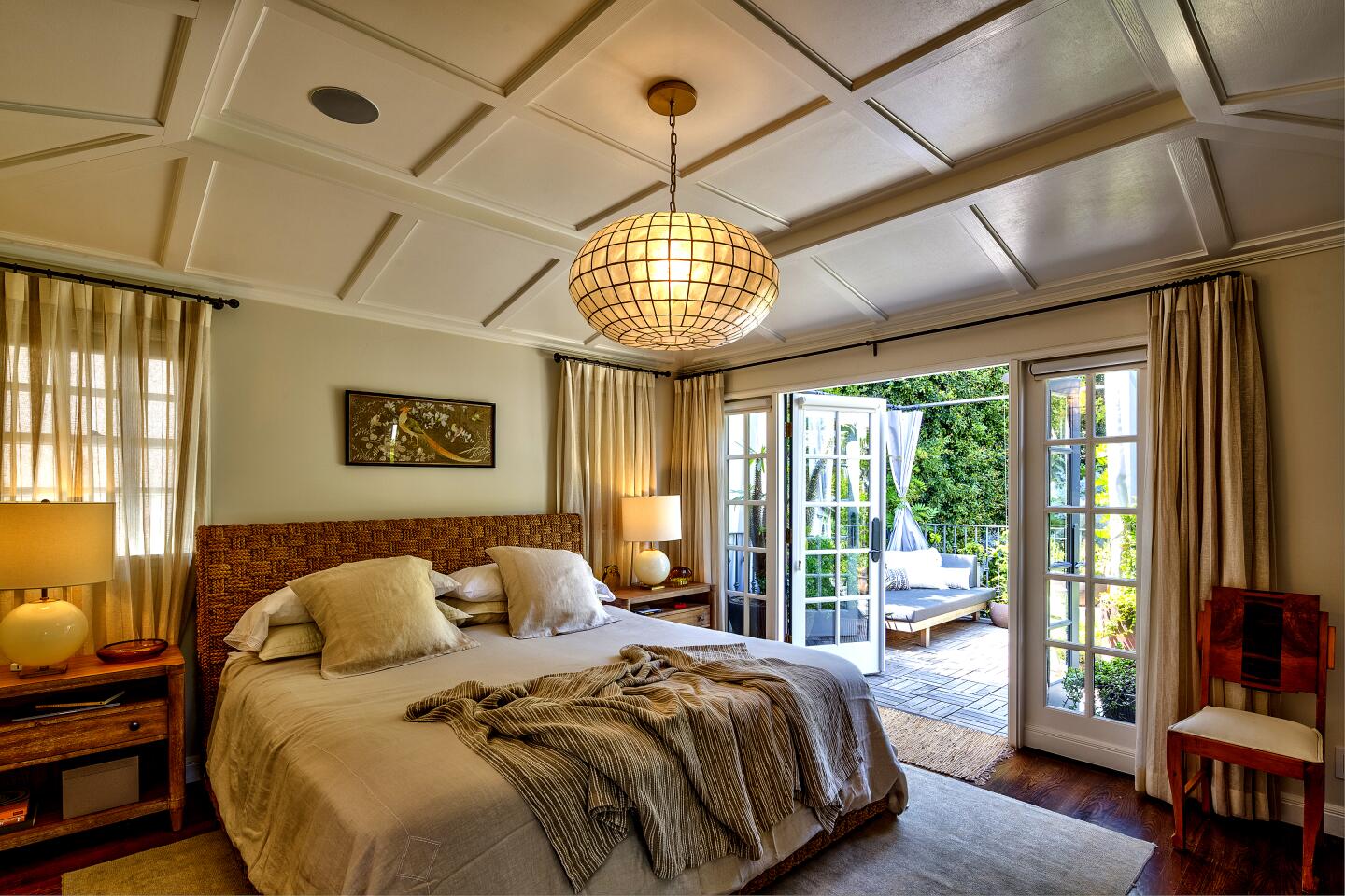 Upstairs, the master suite opens to a private garden balcony.