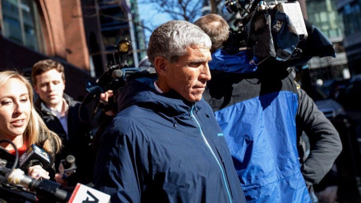 William "Rick" Singer leaves federal court in Boston after being charged with racketeering conspiracy, money laundering conspiracy, conspiracy to defraud the United States, and obstruction of justice on March 12, 2019.
