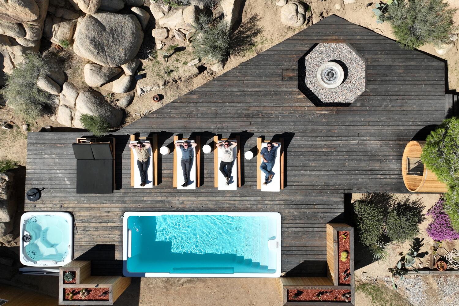 Yucca Valley, CA - October 22: From left: Andrew Fortner, Patryk Swietek, Ryan Cherlin, Josh Rudin, partners of the Cohost Company, a luxury short-term management business, Joshua Tree's largest short-term rental management company, show off a short term rental property in Yucca Valley Wednesday, Oct. 22, 2025. Operators are exiting the short-term rental market in the Joshua Tree area after the pandemic drove the number of listings to record highs. Some are selling, at times facing the prospect of losing money in a real estate market that has cooled. Others are seeking long-term tenants in a bid to offset their mortgages as they wait to see if home sales pick up. (Allen J. Schaben / Los Angeles Times)