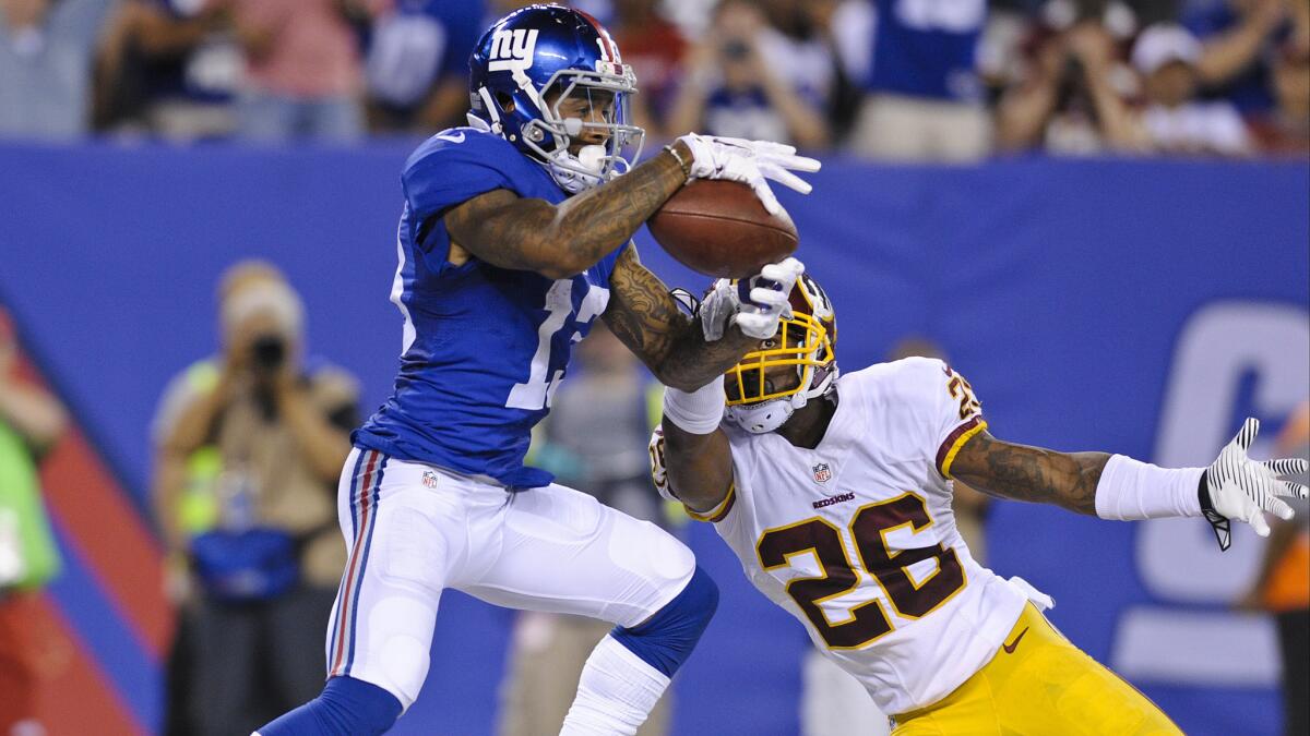 Giants wide receiver Odell Beckham Jr. (13) catches a pass for a touchdown in front of Redskins cornerback Bashaud Breeland (26) in the second half Thursday night at MetLife Stadium.