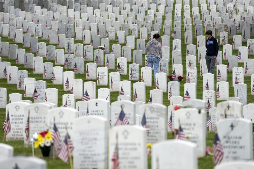 People walk among the headstones as they visit Section 60 at Arlington National Cemetery on Memorial Day, Monday, May 29, 2023, in Arlington, Va. (AP Photo/Alex Brandon)