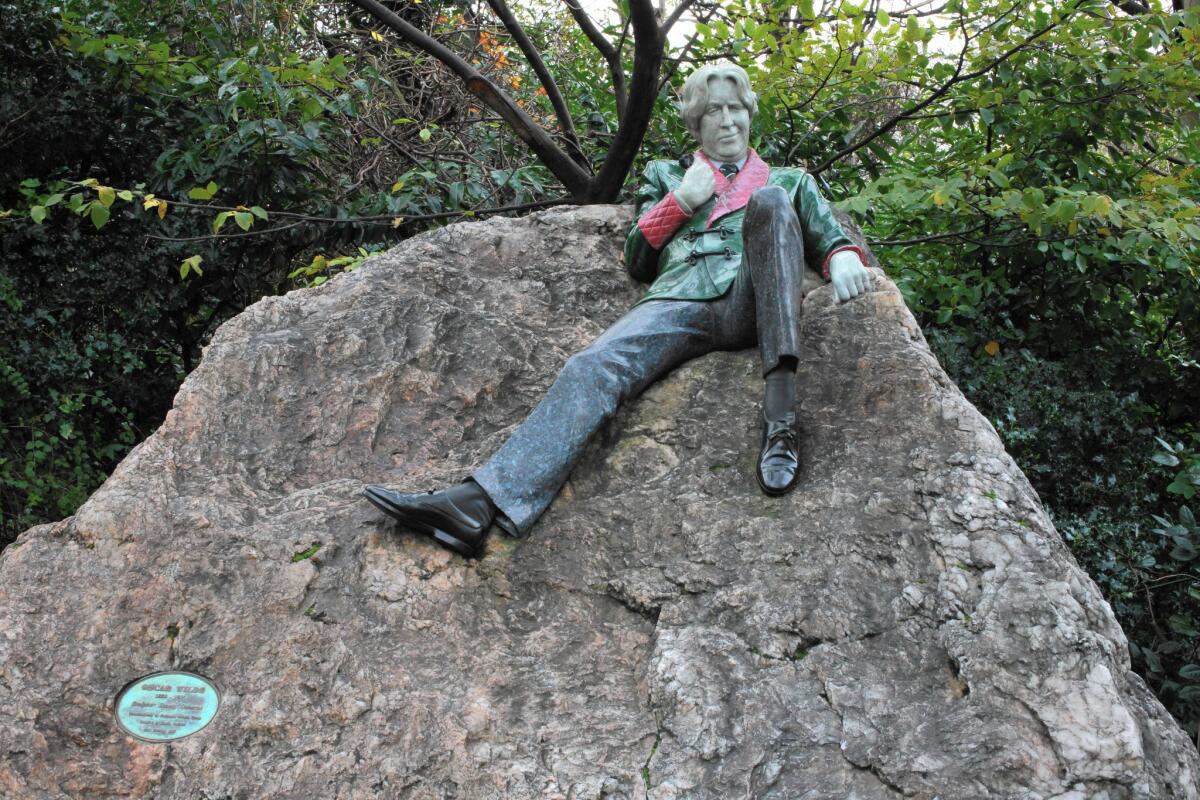 A statue of Irish writer Oscar Wilde reclines rakishly on a boulder in Dublin's Merrion Square Park.