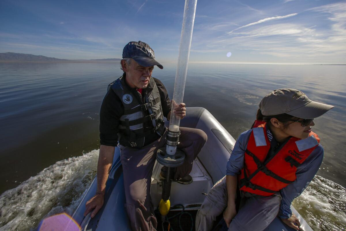 Two people on a boat at the Salton Sea.