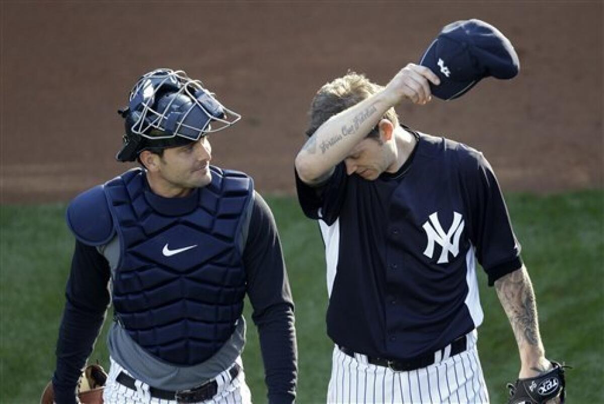 Photo: Yankees' CC Sabathia talks to catcher Jorge Posada during