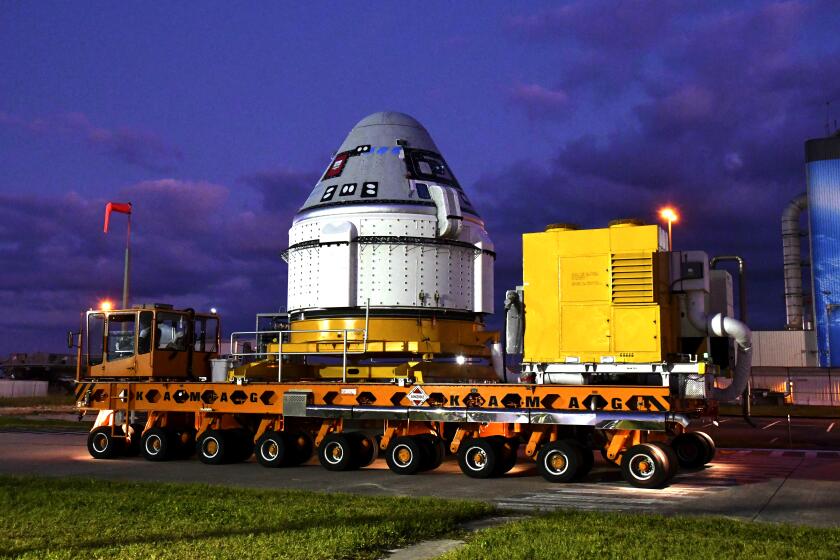 Boeing's Starliner spacecraft is rolled out of Space Florida's Commercial Crew and Cargo Processing Facility (C3PF) before dawn on Thursday, Nov. 21, 2019, at the Kennedy Space Center in Cape Canaveral, Fla. The spaceship is scheduled to fly in December. (Malcolm Denemark/Florida Today via AP)