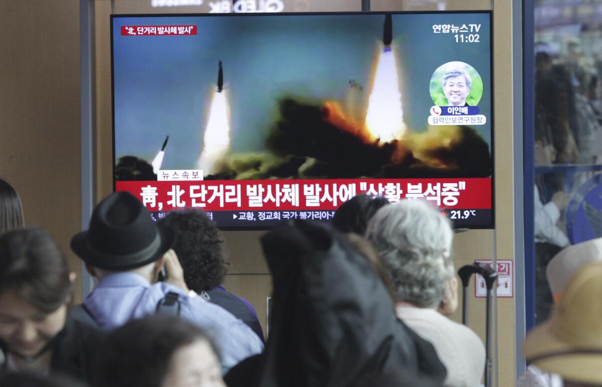 People in Seoul watch a TV news program showing file footage of a North Korean missile launch. North Korea on Saturday fired several unidentified short-range projectiles into the sea off its eastern coast, according to the South Korean military.