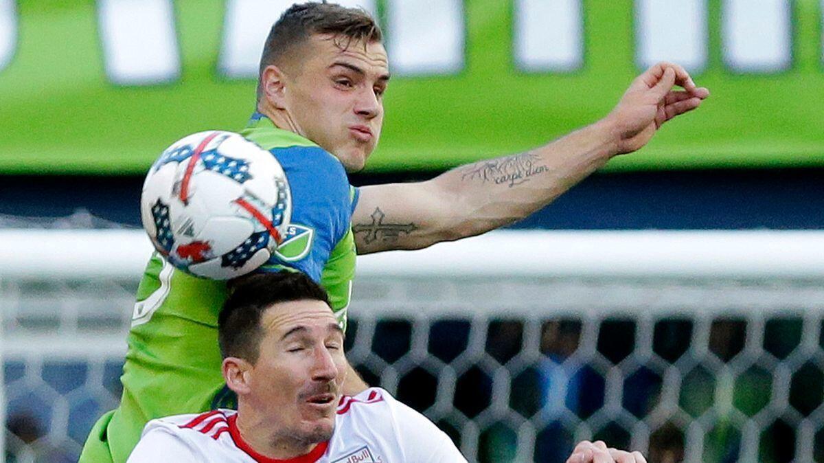 Seattle Sounders forward Jordan Morris, top, and New York Red Bulls midfielder Sacha Kljestan vie for a header. Morris, even though he has been hampered by an ankle injury, is on loan from the Sounders to the U.S. national team for Friday's game against Honduras.
