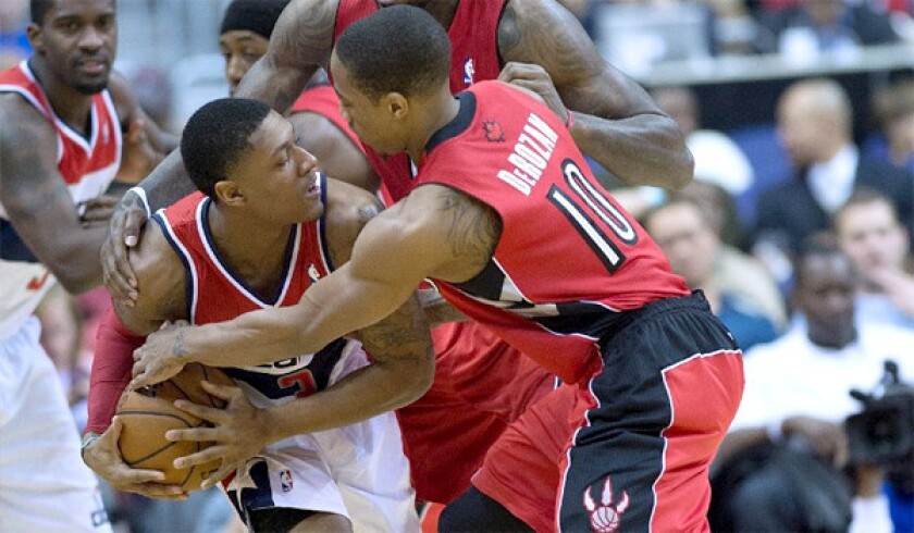 Washington's Bradley Beal and Toronto's DeMar DeRozen struggle for possession of the ball during a Jan. 3 matchup. Both teams are in the playoff hunt in the Eastern Conference.