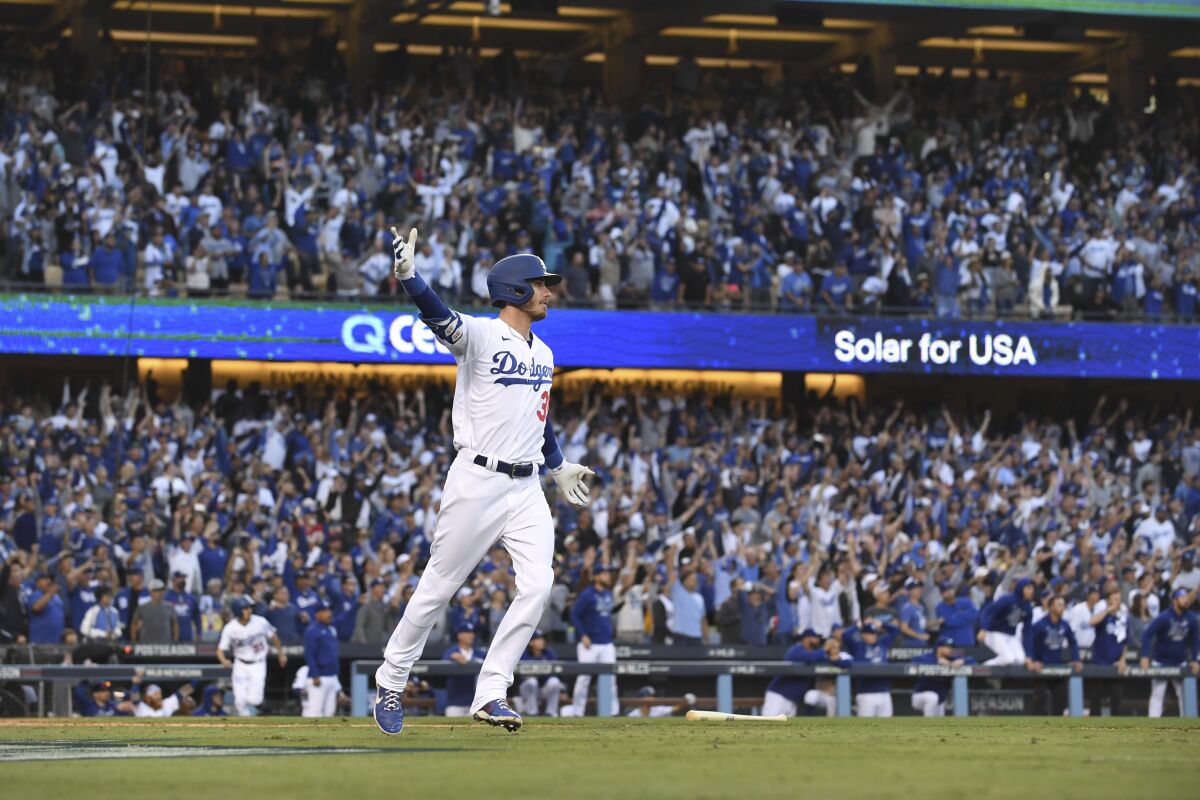 Cody Bellinger celebrates after hitting a three-run home run during the eighth inning.