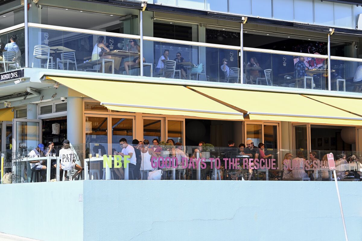 Diners are seen at Bondi Beach in Sydney on Dec. 15, 2021. The premier of Australia’s most populous state said he is not considering lockdowns or other restrictions as a record new COVID-19 cases were reported on Friday, Dec. 17, 2021, the highest number since the pandemic began. (Bianca De Marchi/AAP Image via AP)