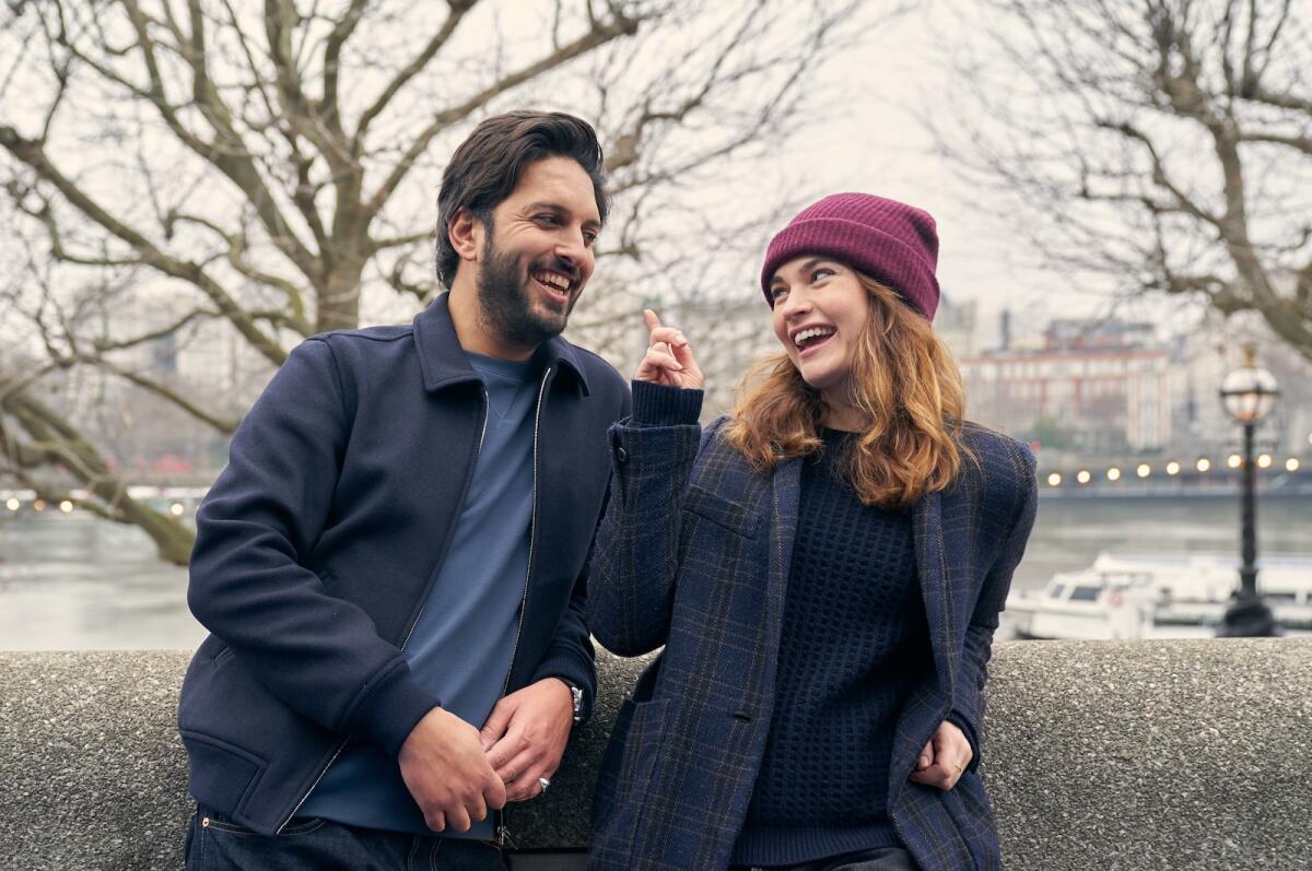 A man and a woman laughing together in a park