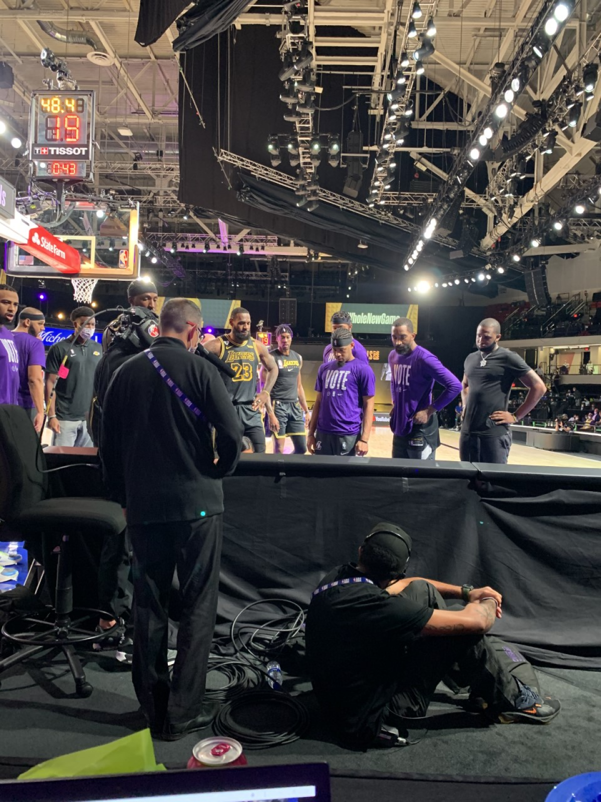Lakers players, including LeBron James, watch as the Lakers medical staff helps forward Anthony Davis.