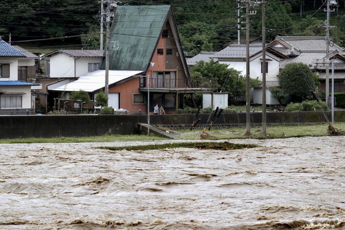 The swollen Hida River following heavy rain July 8 in the Japanese city of Gero.