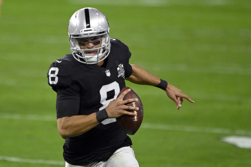 Las Vegas Raiders quarterback Marcus Mariota runs with the ball against the Chargers on Dec. 17.