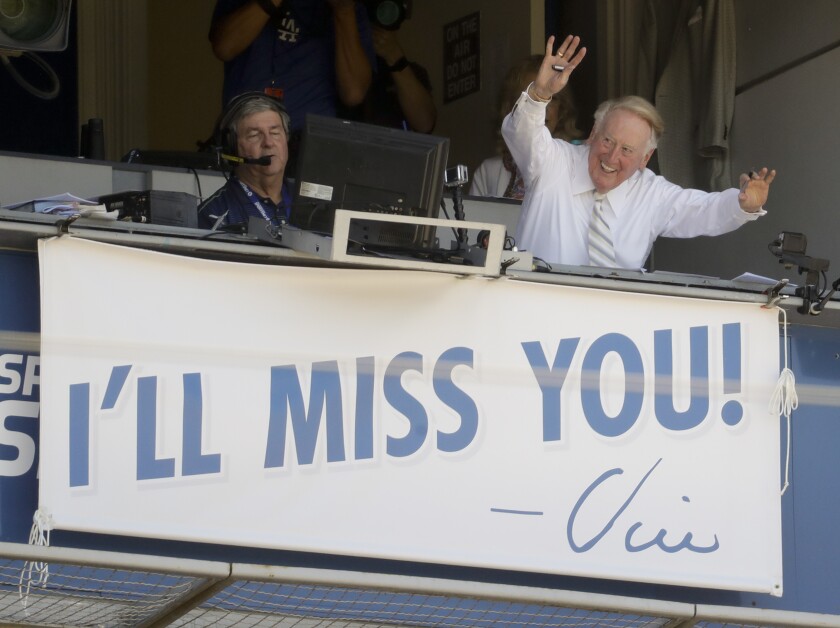 Vin Scully, a Hall of Fame broadcaster waves to the fans at Dodger Stadium 