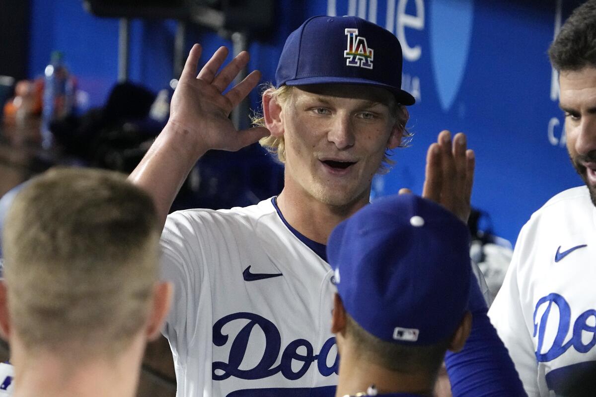 Dodgers' Emmet Sheehan, center, congratulates Mookie Betts after Betts made a great catch on June 16, 2023, in Los Angeles