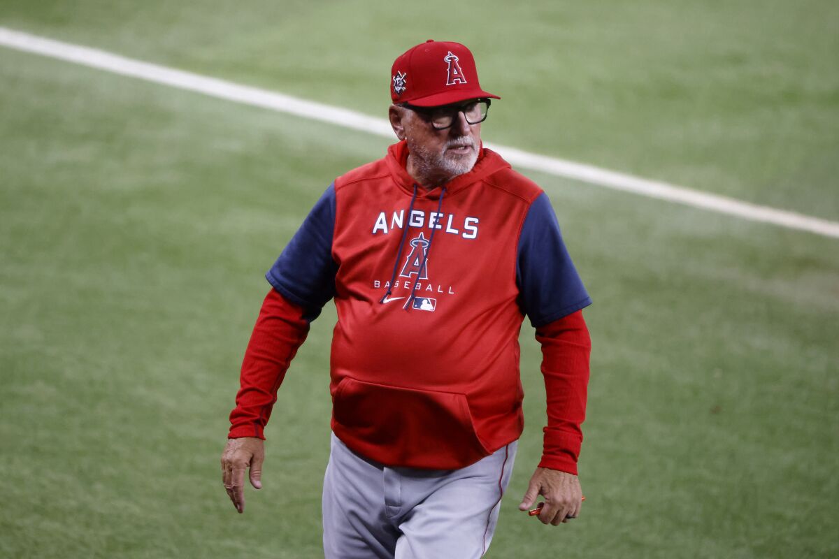 Angels manager Joe Maddon walks off the field after arguing a call in a game against the Texas Rangers on April 15.