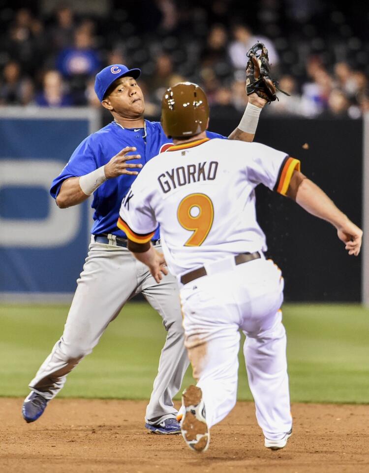 Cubs shortstop Starlin Castro gets the force out on the Padres' Jedd Gyorko before turning a double play during the sixth inning.