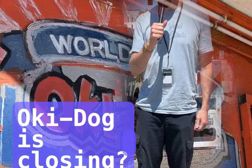 Man standing in front of hot dog stand