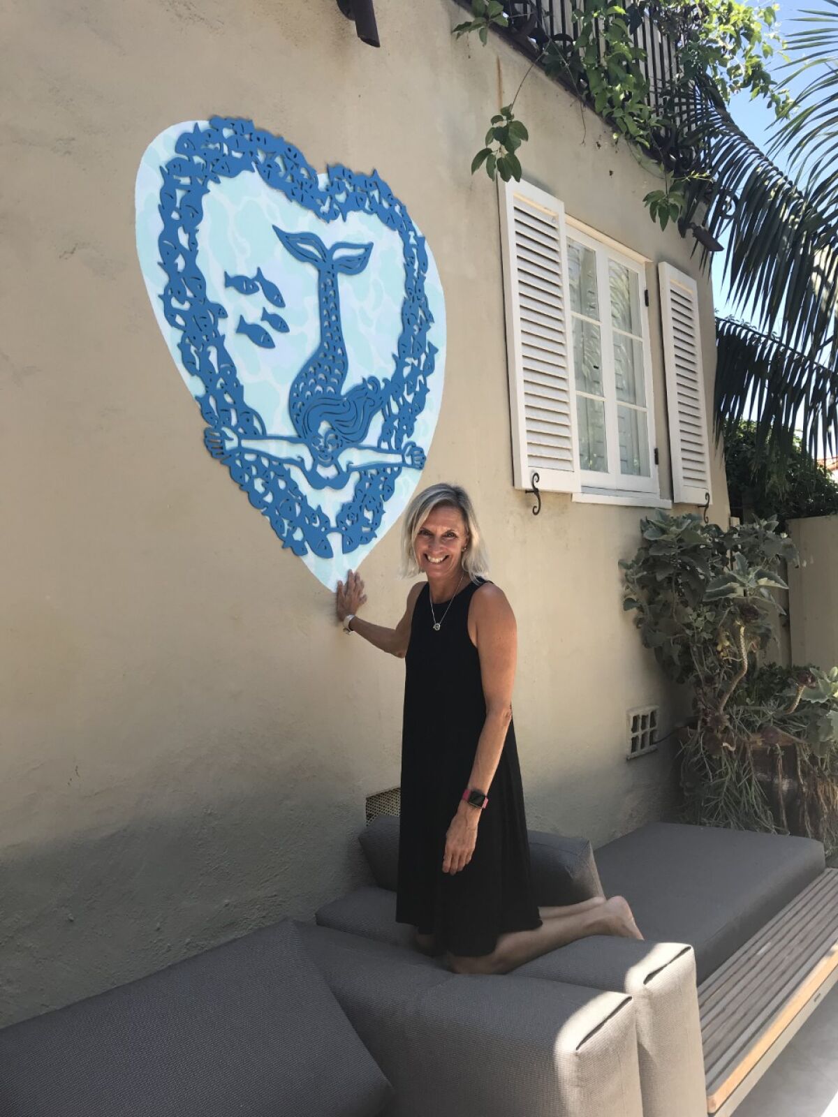 Artist Annika Nelson with a mermaid art installation.