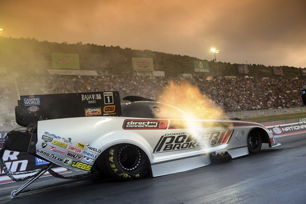 In this photo provided by the NHRA, Matt Hagan drives during Funny Car qualifying for the NHRA Mile-High Nationals drag races Friday, July 15, 2022, at Bandimere Speedway in Morrison, Colo. (Jerry Foss/NHRA via AP)