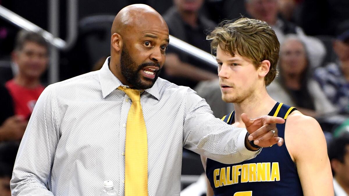 Cuonzo Martin talks to guard Grant Mullins during California's game against Utah in the quarterfinals of the Pac-12 Conference tournament.