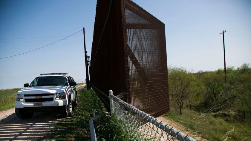 A Border Patrol vehicle guards a section of fence in Runn, Texas, in March 2017.