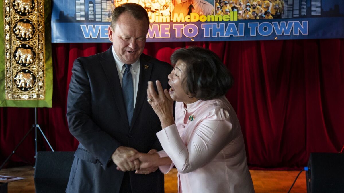 Los Angeles County Sheriff Jim McDonnell greets a Thai Town resident during a campaign stop at Thailand Plaza in Los Angeles.