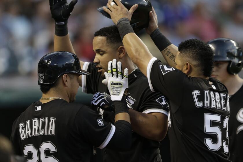 The White Sox’s Jose Abreu, center, is congratulated by teammates after hitting a solo home run off Cleveland Indians starting pitcher Corey Kluber in the sixth inning.