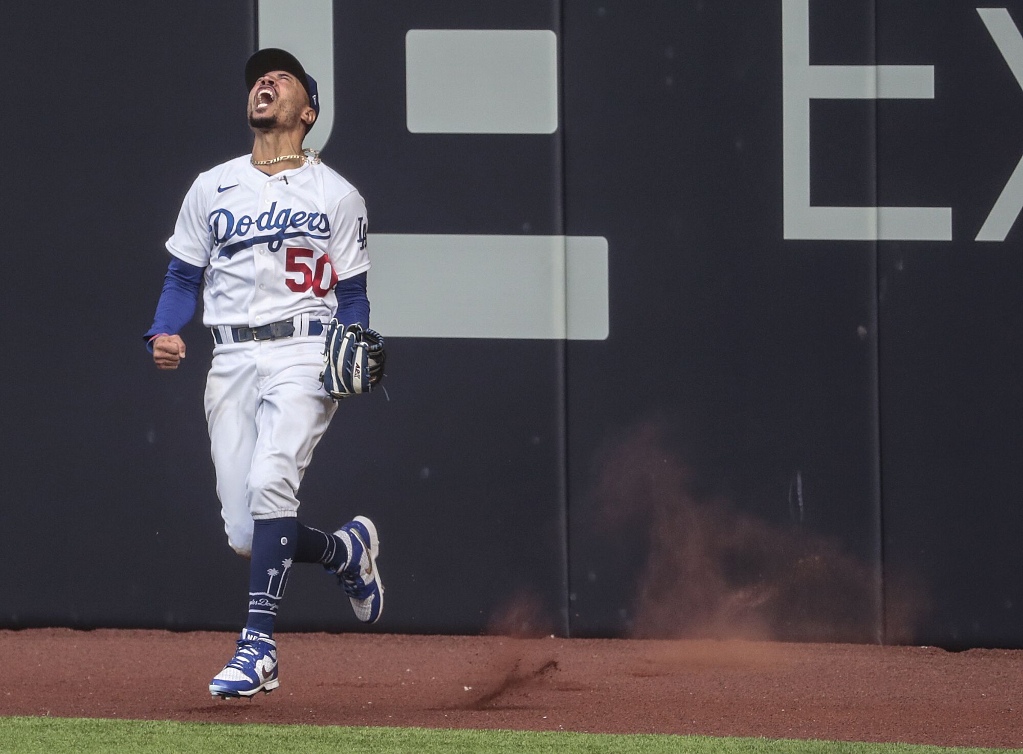 Dodgers right fielder Mookie Betts celebrates after leaping to catch a Marcell Ozuna.