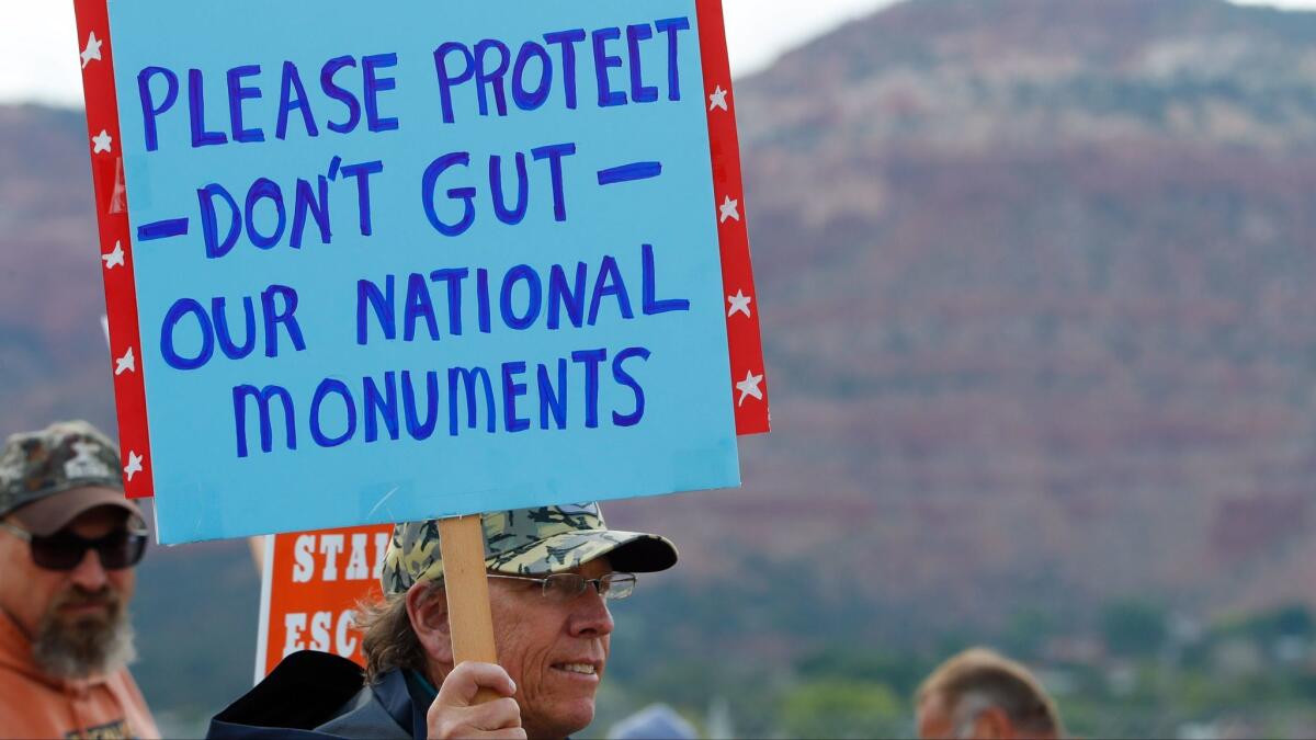 A protest in Kanab, Utah, greets Interior Secretary Ryan Zinke in May.