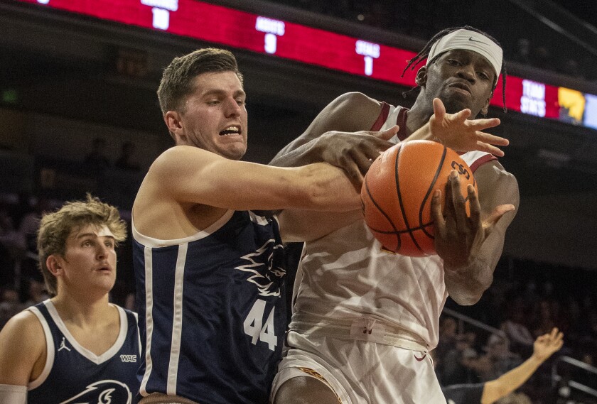 USC striker Chevez Goodwin battles Dixie State's Hunter Schfield for a rebound.