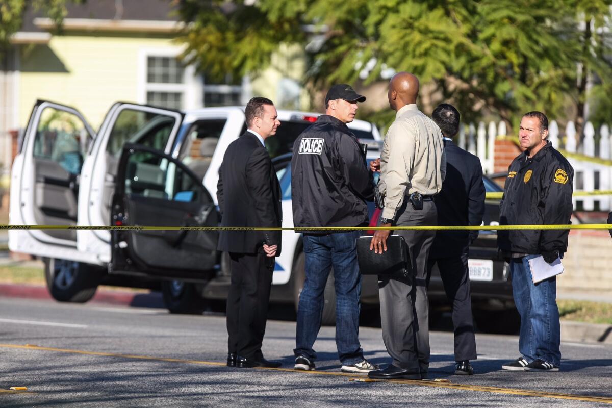 Investigators comb the scene of an officer-involved shooting, in which a kidnapping suspect led Burbank police on a short pursuit Thursday morning. He was shot after slamming his truck into a patrol car, officials said.