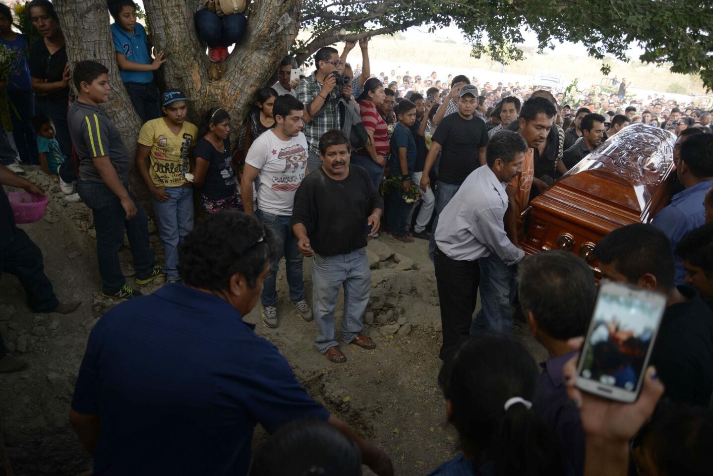 Mourners carry the coffin of slain mayor of Temixco, Gisela Mota, to the cemetery in Pueblo Viejo, Mexico. The governor of the southern Mexican state of Morelos says the killing of the mayor was a warning by drug gangs, meant to convince other officials to reject state police control of local forces. (AP Photo/Tony Rivera)