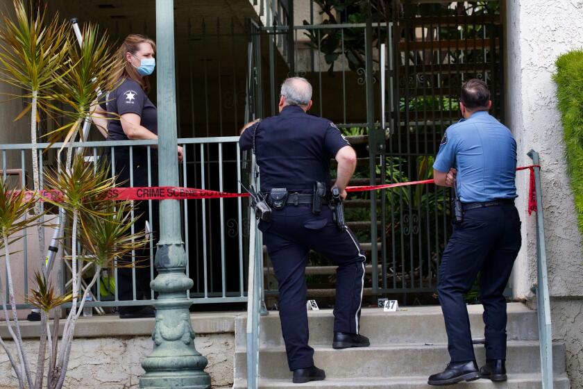 ORANGE CA APRIL 1, 2021 - An investigation is underway following a mass shooting in Orange that claimed the lives of four people, including a 9-year-old boy. Evidence markers and shell casings can be seen where 44-year-old Aminadab Gaxiola Gonzalez is suspected of killing four people in the courtyard of the building in the 200 block of West Lincoln Avenue. (Irfan Khan / Los Angeles Times)