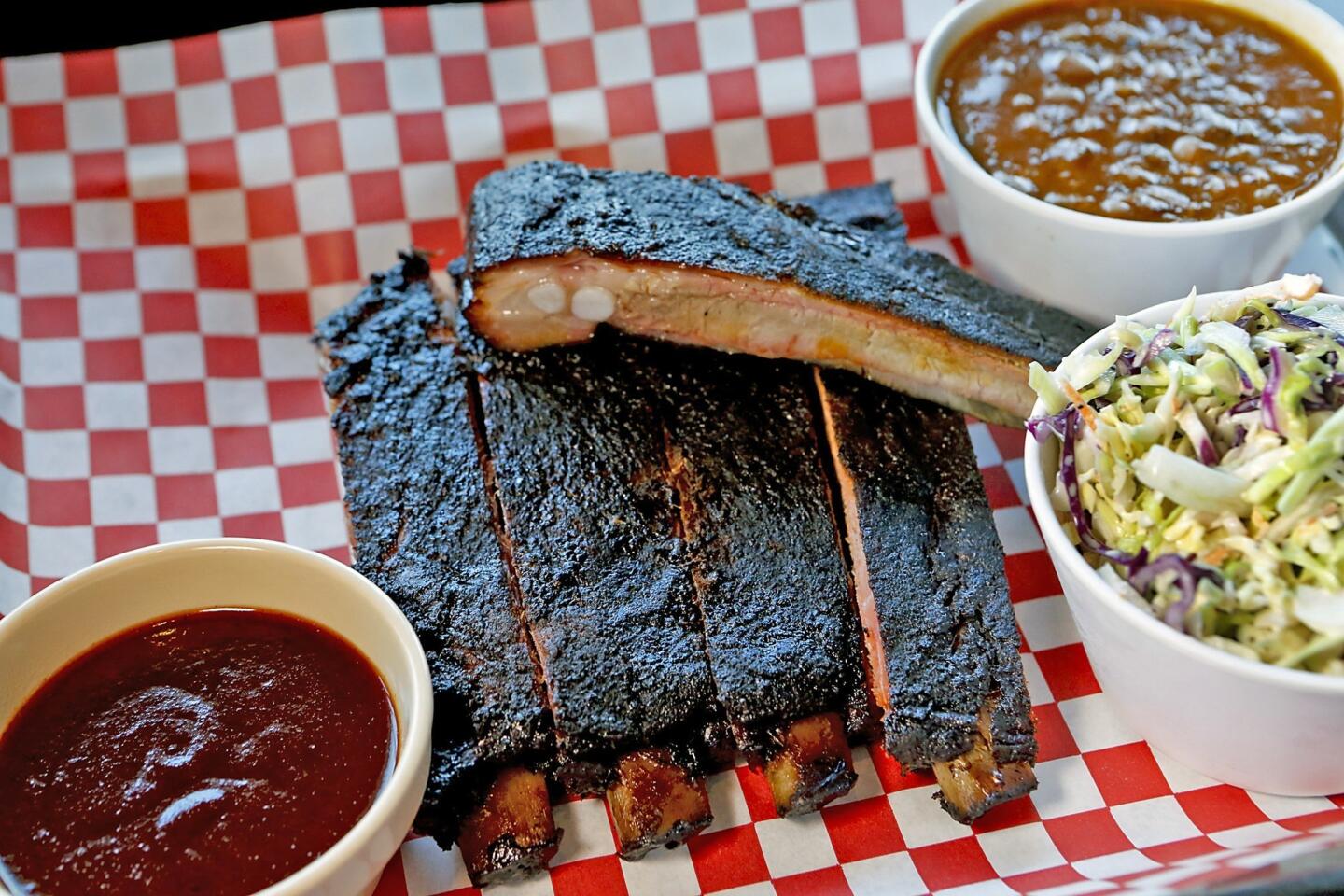 Barbecued pork ribs, baked beans and coleslaw at Bludso's Bar & Que. The original Compton location's fare is all smoke, animal and salt.
