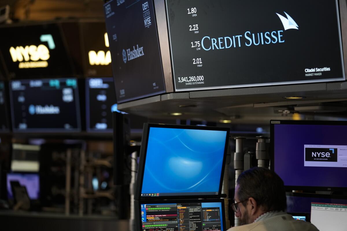 A sign displays the name of Credit Suisse at the New York Stock Exchange.