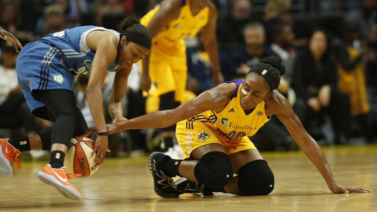 Sparks forward Nneka Ogwumike goes for the steal as Lynx guard Renee Montgomery loses control of the ball in the first half.