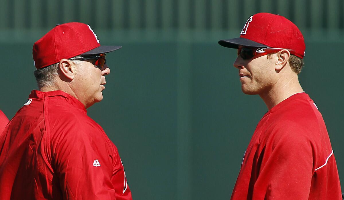Angels Manager Mike Scioscia talks to outfielder Josh Hamilton in 2013.