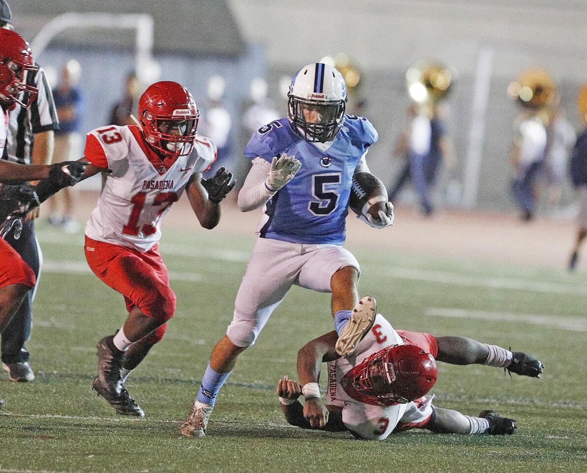 Crescenta Valley's Vincent Parrott high steps to avoid his legs being wrapped up by the Pasadena defense as he runs after a pass in the second quarter in a Pacific League football game Moyse Field in Glendale on Friday, September 21, 2018. Pasadena scored a touchdown in the closing seconds of the first half, but trailed Crescenta Valley 37-6.