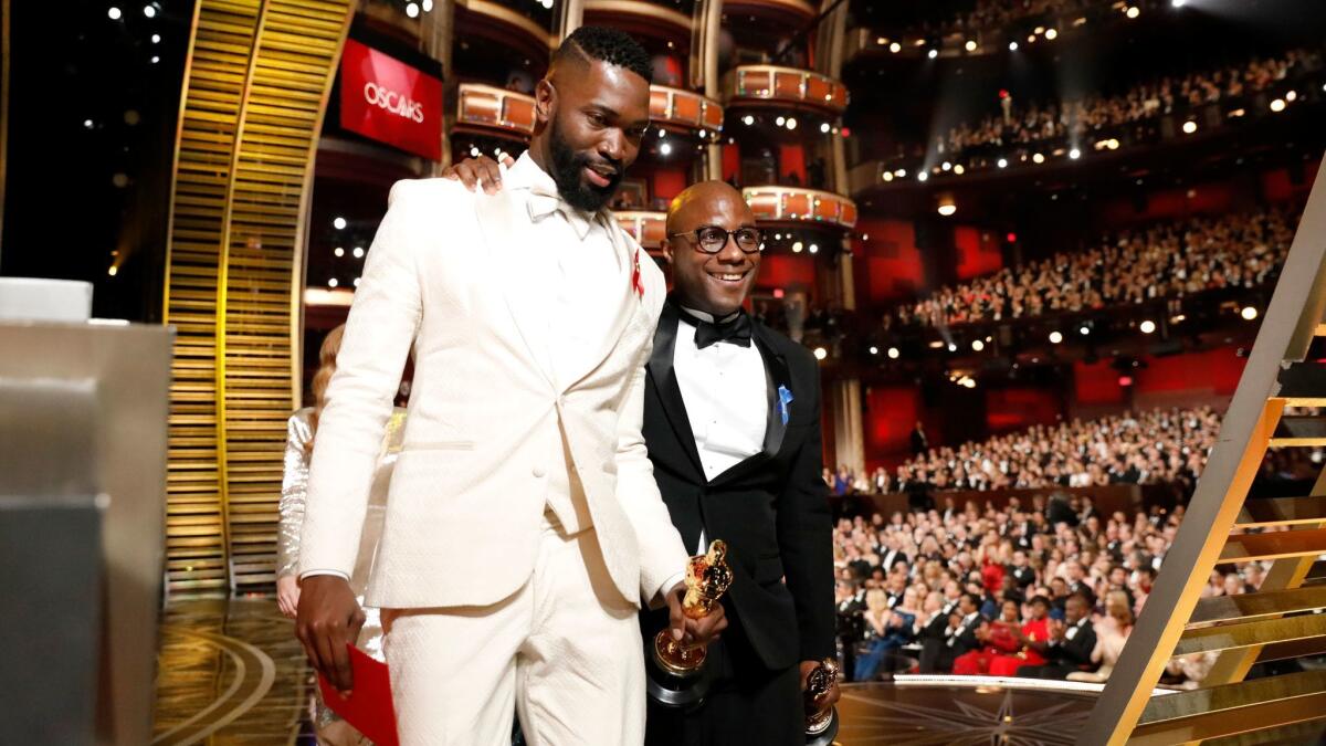 Writer Tarell Alvin McCraney and director Barry Jenkins win the Oscar for adapted screenplay for "Moonlight" at the 89th Academy Awards at the Dolby Theatre.