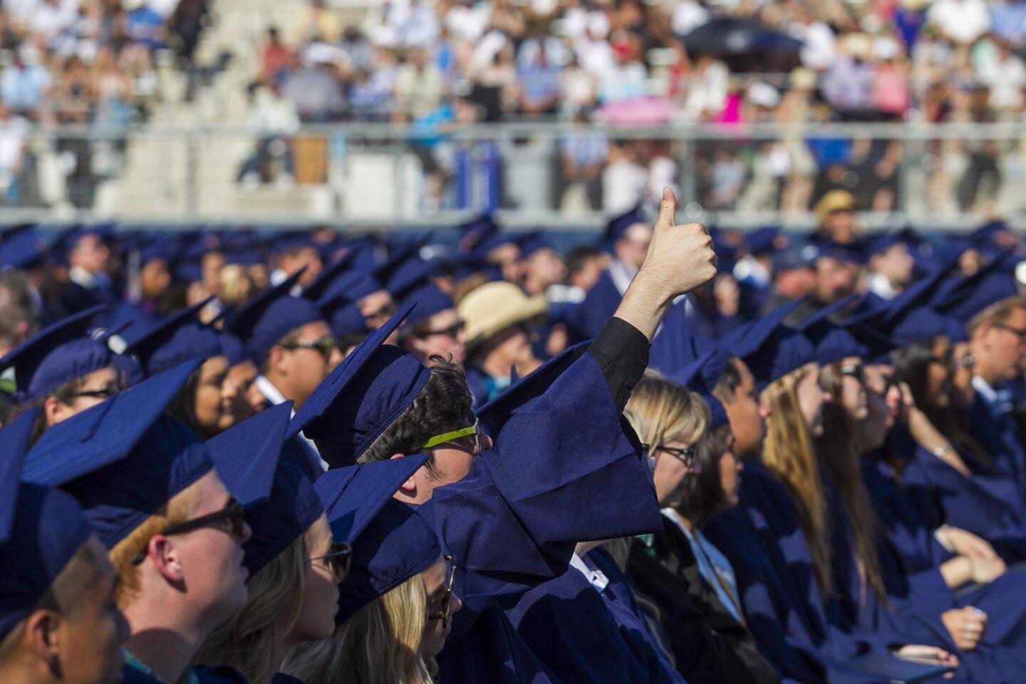 A graduate gives a thumbs up during the 2016 commencement ceremony for Newport Harbor High School at Orange Coast College on Thursday.