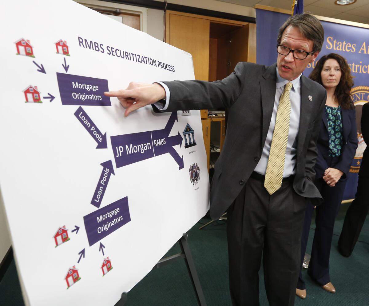 Benjamin Wagner, the United States attorney for the Eastern District of California, with a chart showing how home mortgages were bundled as defective mortgage-backed securities, during a news conference to discuss the $13-billion settlement with JPMorgan Chase & Co., in Sacramento on Tuesday.
